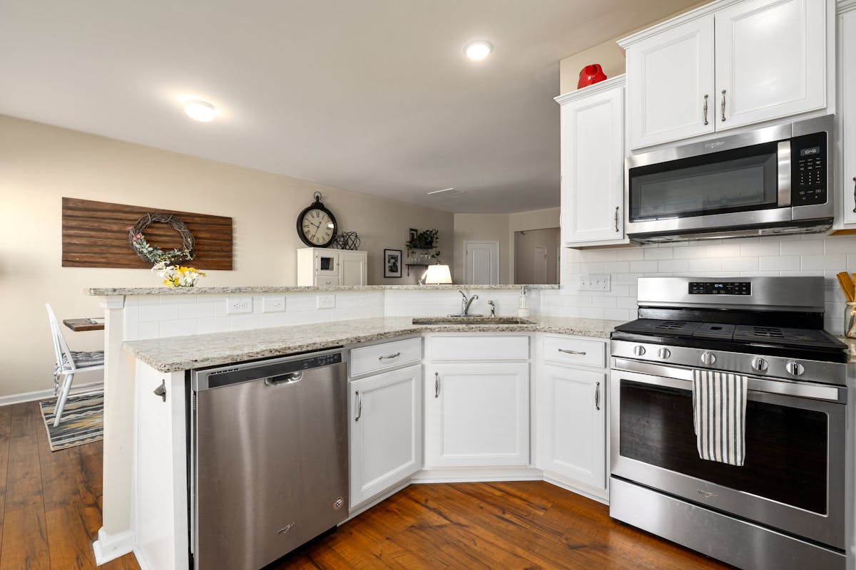 White kitchen cabinet with marble top counter